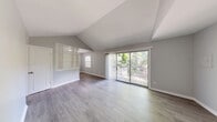 Located at 3270 Milstead in Toledo, OH, this 1-bedroom, 1-bathroom unit offers a well-organized single-floor layout encompassing a living room, dining room, kitchen, hallway, utility room, and three closets. The living room is a standout space, featuring dramatic vaulted ceilings and large sliding glass doors that open to a private outdoor deck, flooding the area with natural light and offering pleasant views of surrounding greenery. Light-toned, hardwood-style flooring runs throughout, complementing the neutral gray wall palette for a clean, cohesive aesthetic. A decorative lattice partition elegantly separates the living and dining areas while maintaining an open feel. The kitchen is equipped with gray cabinetry, gray countertops, a double stainless steel sink, and a range, providing a practical and stylish cooking space. The bedroom is a comfortable, well-proportioned room with a natural light source from a window and a double sliding-door closet. The bathroom includes a tub/shower combo with tiled surround, a vanity with a white sink, and a window for natural ventilation. The utility room and additional closets provide generous storage throughout the unit.