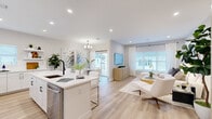 Located at 74 Hauppauge Rd in Commack, NY, this well-appointed three-bedroom, four-bathroom home spans three floors and offers a thoughtfully designed layout with modern finishes throughout. The main living level features a bright, open-concept kitchen, living, and dining area bathed in natural light from large windows and sliding glass doors. The kitchen is outfitted with crisp white cabinetry, quartz countertops, stainless steel appliances, a black matte faucet, and a center island with seating — ideal for both everyday living and entertaining. The adjacent living room exudes a calm, neutral ambiance with light hardwood flooring and stylish décor. A dedicated dining area and half bath with marble-style tile flooring round out the main level. Upstairs, the generously sized primary bedroom is a true retreat, featuring a private balcony with neighborhood views, a walk-in closet with built-in wire shelving, and serene natural light. Two additional bedrooms and well-appointed bathrooms provide comfortable accommodations. A dedicated laundry room with side-by-side washer and dryer adds everyday convenience. Clean lines, recessed lighting, and a cohesive neutral palette create an inviting, move-in-ready atmosphere throughout.