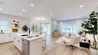 Located at 74 Hauppauge Rd in Commack, NY, this well-appointed three-bedroom, four-bathroom home spans three floors and offers a thoughtfully designed layout with modern finishes throughout. The main living level features a bright, open-concept kitchen, living, and dining area bathed in natural light from large windows and sliding glass doors. The kitchen is outfitted with crisp white cabinetry, quartz countertops, stainless steel appliances, a black matte faucet, and a center island with seating — ideal for both everyday living and entertaining. The adjacent living room exudes a calm, neutral ambiance with light hardwood flooring and stylish décor. A dedicated dining area and half bath with marble-style tile flooring round out the main level. Upstairs, the generously sized primary bedroom is a true retreat, featuring a private balcony with neighborhood views, a walk-in closet with built-in wire shelving, and serene natural light. Two additional bedrooms and well-appointed bathrooms provide comfortable accommodations. A dedicated laundry room with side-by-side washer and dryer adds everyday convenience. Clean lines, recessed lighting, and a cohesive neutral palette create an inviting, move-in-ready atmosphere throughout.