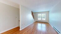 Located at 554 Connecticut Ave in Norwalk, Connecticut, this two-story, two-bedroom, two-bathroom home offers a well-organized layout spread across two floors. The main floor provides generous living space, while the upper floor encompasses the bedrooms and additional amenities, connected by a dedicated staircase and hallway.

Throughout the home, warm hardwood flooring is a consistent and standout feature, adding a sense of warmth and continuity to each room. The bedrooms are well-proportioned, with large windows that invite natural light and offer views of the surrounding greenery. The primary bedroom is notably spacious, complete with a built-in closet for practical storage. Baseboard heating is present throughout, ensuring year-round comfort.

Both bathrooms are clean and functional. The full bathroom includes a tub-shower combination, a white vanity with ample storage, and light tile flooring. A second, more compact bathroom provides convenient additional facilities.

One of the home's most appealing features is the private balcony, which overlooks a lush, tree-lined backyard. The outdoor space is bathed in natural light and offers a peaceful retreat surrounded by mature trees and well-maintained greenery.

The overall aesthetic is neutral and bright, with light gray walls and white trim throughout, creating a move-in-ready canvas that is both versatile and inviting.
