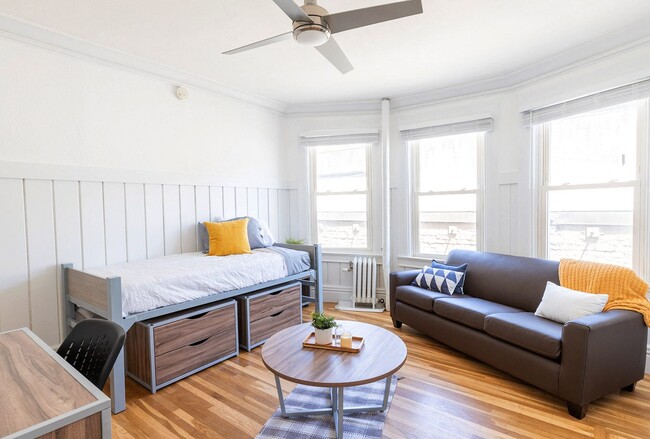 Living area with large window, sofa, and table - 2510 Bancroft Way