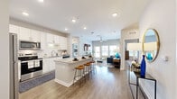 Located at 6120 Burnett St in Lakeland, FL, this single-story, 2-bedroom, 2-bathroom home offers a thoughtfully designed open-concept layout that seamlessly connects the kitchen, dining area, and living room. The kitchen is a standout feature, boasting white shaker cabinets, granite countertops, stainless steel appliances, and a central island with bar seating — ideal for both everyday cooking and entertaining. Wood-look flooring flows throughout the main living areas, adding warmth and cohesion to the space.

The living room is bright and welcoming, with large windows that invite abundant natural light and a ceiling fan overhead. The primary bedroom features plush carpeting, generous natural light from multiple windows, and a ceiling fan, while a dedicated closet and an en-suite bathroom with granite countertops and a tiled tub-shower combination add practicality and comfort. The second bedroom is equally well-appointed with similar finishes and a shared full bathroom nearby.

A dedicated laundry room houses a full-size washer and dryer. A connecting hallway links all rooms efficiently. Neutral tones, recessed lighting, and clean modern design choices give this home a bright, move-in-ready appeal throughout.