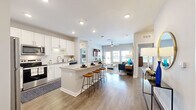 Located at 6120 Burnett St in Lakeland, FL, this single-story, 2-bedroom, 2-bathroom home offers a thoughtfully designed open-concept layout that seamlessly connects the kitchen, dining area, and living room. The kitchen is a standout feature, boasting white shaker cabinets, granite countertops, stainless steel appliances, and a central island with bar seating — ideal for both everyday cooking and entertaining. Wood-look flooring flows throughout the main living areas, adding warmth and cohesion to the space.

The living room is bright and welcoming, with large windows that invite abundant natural light and a ceiling fan overhead. The primary bedroom features plush carpeting, generous natural light from multiple windows, and a ceiling fan, while a dedicated closet and an en-suite bathroom with granite countertops and a tiled tub-shower combination add practicality and comfort. The second bedroom is equally well-appointed with similar finishes and a shared full bathroom nearby.

A dedicated laundry room houses a full-size washer and dryer. A connecting hallway links all rooms efficiently. Neutral tones, recessed lighting, and clean modern design choices give this home a bright, move-in-ready appeal throughout.