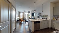 Located at 10315 Monrovia Dr in Matthews, NC, this single-floor residence offers a thoughtfully designed open-concept layout that seamlessly connects the kitchen, dining, and living areas. The kitchen is a standout feature, boasting granite countertops, an oversized island with a undermount sink, white shaker cabinetry, stainless steel appliances including a refrigerator, range, and microwave, subway tile backsplash, track lighting, and stylish pendant lights. Rich dark hardwood-style flooring flows throughout the main living areas, adding warmth and continuity.

The living room is bright and welcoming, with large windows dressed with blinds that invite natural light. Multiple bedrooms offer plush carpeting and generous window coverage, each providing a comfortable, private retreat. The primary bathroom features granite countertops, dark cabinetry, a glass-enclosed shower, and direct access to a walk-in closet. A secondary bathroom includes a soaking tub with shower combo and similarly leads to an additional walk-in closet. The entry area provides a convenient drop zone. Throughout, the design balances modern finishes with a warm, livable ambiance suited for everyday comfort.