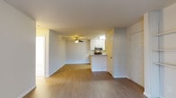 This single-floor residence offers a clean, functional layout with a bright and open feel throughout. The main living area features light hardwood-style flooring, neutral walls, and a ceiling fan, creating a comfortable and airy atmosphere. The kitchen is efficiently designed with a peninsula counter featuring granite-style countertops and an undermount sink, light wood cabinetry reaching to the ceiling, and a full suite of stainless steel appliances including a range, microwave, and refrigerator. The peninsula opens directly to the living space, making the layout ideal for everyday living. A fireplace serves as a focal point in the living room, which also benefits from a large sliding glass door that invites natural light and provides outdoor access. The bedrooms are carpeted for warmth and comfort, each featuring windows that bring in natural light and baseboard heating units. The bathrooms are finished with granite-style countertops, white cabinetry, and light wood-style flooring. One bathroom includes a tub and shower combination with frosted sliding glass doors, while another features a vanity with a large mirror. The overall design is neutral and move-in ready, with a cohesive palette of soft whites and beiges throughout.