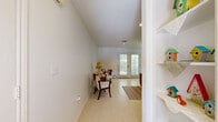 Located at 501 Garden Ridge Dr in Livingston, Texas, this single-story, one-bedroom, two-bathroom home offers a well-organized and functional layout across a compact footprint. The bright living room serves as the heart of the home, featuring light-toned tile flooring, recessed lighting, and a set of French doors that invite natural light and provide outdoor access. A dedicated dining area sits adjacent to the living space, lit by a multi-bulb chandelier and brightened by a window overlooking the outdoors. The galley-style kitchen is equipped with warm wood cabinetry, gray laminate countertops, a double stainless steel sink, and white appliances, with tile flooring that complements the functional layout. The spacious primary bedroom includes a ceiling fan, a large window for natural light, and access to a generously sized walk-in closet outfitted with multiple shelving rods on three walls. Two bathrooms serve the home; one features a vanity with wood cabinetry and a large mirror, while the other includes a glass-door shower and additional storage. Throughout the home, a neutral color palette and consistent flooring create a cohesive, easy-to-maintain interior well-suited for comfortable everyday living.