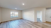 This well-appointed one-bedroom, one-bathroom residence at 9000 Lyla Way in Bordentown, NJ offers a thoughtfully designed single-floor layout with contemporary finishes throughout. Light-toned wood-style flooring runs consistently across the living spaces, lending a clean and cohesive aesthetic to the entire home.

The open-concept kitchen and living area serves as the heart of the residence. The kitchen is equipped with stainless steel appliances, including a gas range, built-in microwave, and a French door refrigerator. Light wood cabinetry provides ample storage, while a peninsula with a crisp white countertop offers additional prep space and casual seating. Recessed lighting and pendant fixtures illuminate the area effectively.

The living room is bright and airy, benefiting from natural light through large windows and a sliding glass door that opens to a private balcony with an exterior railing — a standout feature of this space.

The generously sized primary bedroom features a double-door closet and neutral walls, creating a calm and versatile retreat. The full bathroom is finished with tile flooring, a white vanity with a dark countertop, and a well-lit mirror above the sink. The overall palette of warm neutrals and white trim throughout contributes to a fresh, move-in-ready ambiance.