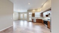 Located at 375 Osprey Ln in Independence, Oregon, this single-floor, 3-bedroom, 3-bathroom residence offers a well-designed layout with a clean, contemporary aesthetic throughout. Light-toned luxury vinyl plank flooring flows seamlessly across the entire space, complemented by neutral warm-beige walls and recessed lighting that create a bright, welcoming atmosphere.

The open-concept living, dining, and kitchen area forms the heart of the home. The kitchen is well-appointed with rich walnut-toned cabinetry, white countertops, stainless steel appliances including a dishwasher and electric range, and a window above the sink that brings in natural light. The expansive living and dining area extends generously, with multiple windows overlooking the surrounding neighborhood.

Three well-proportioned bedrooms each feature windows with views of outdoor greenery, providing natural light and ventilation. The primary bedroom includes its own dedicated closet, while five closets total throughout the residence offer abundant storage. Each of the three bathrooms maintains the same cohesive design language, featuring walnut cabinetry with white countertops and tile-style flooring. A dedicated laundry area and a private balcony round out the functional amenities of this thoughtfully designed home.