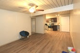 Located at 3002 4th St in Lubbock, Texas, this single-floor unit offers a thoughtfully designed layout that balances comfort and functionality. Throughout the main living and kitchen areas, warm wood-look luxury vinyl plank flooring runs underfoot, complemented by a distinctive slatted ceiling treatment that adds architectural character to the space.

The kitchen is a standout feature, showcasing rich dark espresso cabinetry paired with granite-look countertops and a classic white subway tile backsplash. Stainless steel appliances — including an electric range and built-in microwave — provide a modern, polished finish to the cooking space. Ample upper and lower cabinetry offers generous storage throughout.

The open living area flows naturally from the kitchen, providing a versatile space with the same wood-look flooring and neutral wall tones that keep the atmosphere bright and welcoming. Bedroom spaces feature plush carpeting and ceiling fans, with windows dressed in horizontal blinds that allow for natural light while maintaining privacy. The slatted ceiling detail carries consistently through these rooms, reinforcing the home's cohesive design aesthetic.

The bathroom is well-appointed with dark espresso cabinetry, a granite-topped vanity, a framed mirror, and brushed nickel fixtures, lending a refined touch to the space. Overall, the unit presents a clean, updated interior with consistent finishes throughout.
