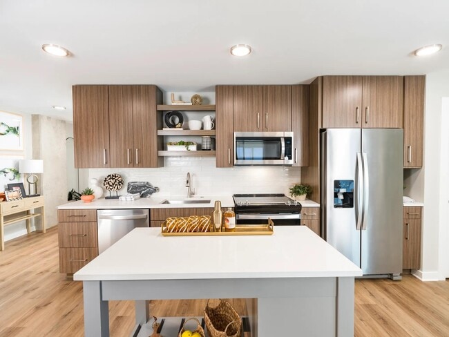 Custom cabinetry and quartz counters in a true chef’s kitchen. - Modera LoSo