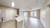 This contemporary 650 square foot apartment in Towson, MD offers a thoughtful blend of style and functionality. The single-floor layout maximizes space efficiency, featuring one bedroom, one bathroom, and an open-concept living area. The primary bedroom, measuring 140 square feet, provides ample space for rest and relaxation.

Throughout the apartment, large windows flood the rooms with natural light, creating an airy and inviting atmosphere. The modern aesthetic is enhanced by neutral-toned walls and sleek wood-look flooring, establishing a cohesive design throughout the space.

The kitchen boasts stainless steel appliances and a practical island, perfect for meal preparation or casual dining. The adjacent living room offers flexibility for various furniture arrangements, ideal for both relaxation and entertaining.

The bathroom features a full-sized tub-shower combination with clean, white tiling, maintaining the apartment's modern appeal. A generously sized closet with built-in shelving provides ample storage solutions.

Additional amenities include a ceiling fan for improved air circulation and strategically placed lighting fixtures. The apartment's location at 960 Southerly Rd. places residents in the heart of Towson, offering both urban convenience and suburban comfort.