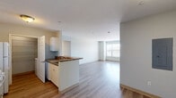 Located at 80 Ferry St in Middletown, CT, this single-floor residence offers three bedrooms and two bathrooms within a thoughtfully laid-out floor plan. Light wood-style flooring runs consistently throughout, providing a clean and cohesive look across all rooms.

The open-concept kitchen and living area serves as the heart of the home. The kitchen features white cabinetry, dark stone-toned countertops, a gas range, a full-size refrigerator, a dishwasher, and a peninsula that opens directly to the living space. A dedicated pantry with built-in wire shelving provides additional storage. Natural light flows in through large windows, brightening both the kitchen and the adjoining living area.

The three bedrooms are well-proportioned and bright, each featuring large windows with blinds that allow for natural light control. The primary bedroom is notably spacious and includes multiple closets, with louvered and paneled doors offering generous storage capacity. The additional bedrooms are well-sized and similarly well-lit.

The two bathrooms are finished with wood-look flooring, white vanities with stone-toned countertops, and full tub-shower combinations with white tile surrounds. A hallway connects the bedrooms and bathrooms, contributing to a functional and organized layout throughout the residence.