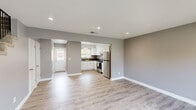 Located at 3141 Thurber Ln in Santa Cruz, California, this two-bedroom, two-bathroom home is thoughtfully laid out across two floors of comfortable living space. Light wood-style flooring flows throughout, complementing a neutral gray and white color palette that lends a clean, modern aesthetic to every room.

The ground floor opens into a bright living room featuring recessed lighting, large windows with garden views, and a warm wood-paneled front door. The adjacent kitchen is well-appointed with white shaker-style cabinetry, dark countertops, a stainless steel range, and a full-size refrigerator, all connected in an efficient layout ideal for everyday use.

Upstairs, the spacious primary bedroom offers generous room to move, dual closets, and sliding glass doors that open to a private outdoor deck — a standout feature perfect for enjoying the California climate. The second bedroom is comfortably sized with a large window that brings in natural light. Both bathrooms are finished with clean white tile and modern fixtures; one includes a walk-in shower with frosted glass doors and a high clerestory window. A dedicated hallway and staircase connect the two levels efficiently, completing this well-designed Santa Cruz home.