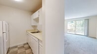 Located at 45769 Timothy Ave in Chilliwack, BC, this 2-bedroom, 1-bathroom unit offers a practical and comfortable single-floor layout. The living room is a bright, open area finished with neutral-toned carpet and features a sliding glass door that opens onto a private balcony with outdoor views, as well as a baseboard heating system. Adjacent to the living area, the compact kitchen is thoughtfully designed with white cabinetry, light countertops, a stainless steel sink, and tile flooring, with a dishwasher included.

The generously sized primary bedroom is carpeted and filled with natural light from a window overlooking greenery. It includes a built-in closet with bifold doors, providing ample storage. The second bedroom is equally well-lit and carpeted, offering a comfortable and versatile space. The full bathroom features a clean, white tub-shower combination with built-in shelving. Throughout the unit, the bright white walls and light finishes create a clean and airy atmosphere. Multiple laundry areas add a notable convenience to this well-organized unit.