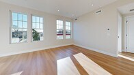 Located at 775 Morton St W in Boston's Mattapan neighborhood, this thoughtfully designed 2-bedroom, 1-bathroom unit offers a compact yet functional single-floor layout with contemporary finishes throughout. Light hardwood flooring runs consistently across all rooms, creating a cohesive and clean aesthetic.

The open kitchen and living area forms the heart of the unit. The kitchen is well-appointed with white shaker-style cabinetry, gold-accented hardware, light stone countertops, a white tile backsplash, and a full suite of stainless steel appliances including a refrigerator, electric range, over-the-range microwave, and dishwasher.

Both bedrooms are filled with natural light courtesy of multiple large double-hung windows offering neighborhood views. The primary bedroom features several windows across two walls, while the secondary bedroom also benefits from generous window placement and a bright, neutral palette with recessed lighting.

The bathroom includes a full soaking tub and shower combination, a toilet, and marble-look tile flooring with white panel walls, accessed via a paneled door with gold hardware. The unit also includes a dedicated entrance and hallway, completing a clean, modern layout suited for comfortable everyday living.