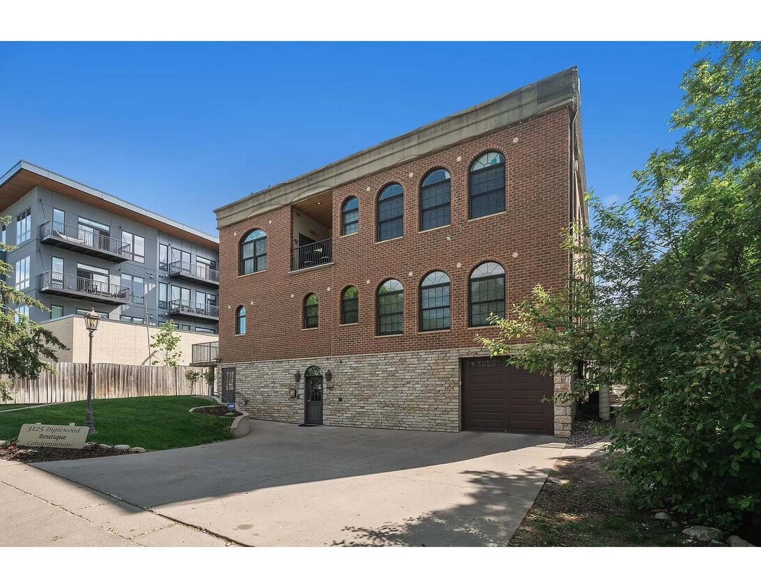 Exterior of building. West facing, garage door to indoor parking garage. West-facing balcony - 3125 Inglewood Ave S