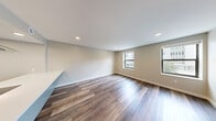 Located at 201 Michigan St NW in the heart of Grand Rapids, Michigan, this well-appointed 2-bedroom, 3-bathroom residence offers a thoughtfully designed single-floor layout with modern finishes throughout. The open-concept kitchen and living area serves as the centerpiece of the home, featuring a galley-style kitchen equipped with stainless steel appliances, gray cabinetry, white quartz countertops, open shelving, a subway tile backsplash, and recessed lighting. Hardwood-style flooring flows throughout the main living areas, lending a warm, cohesive aesthetic. The living space is bright and welcoming, benefiting from natural light through multiple windows. Both bedrooms are carpeted for comfort, each offering generous closet storage with built-in shelving and hanging rods. The primary bedroom features dual windows that bring in ample natural light. The three bathrooms are finished in a clean, contemporary style, with large-format tile flooring, floating vanities with white countertops, and chrome fixtures. One bathroom includes a soaking tub with a tiled surround and a double-sink vanity. A connecting hallway with additional storage ties the layout together efficiently, creating a functional and stylish living environment.
