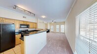 This 1,180 square foot townhouse in Glen Allen, Virginia offers a well-designed living space across three floors. The property features two bedrooms and two bathrooms, with the primary bedroom boasting a generous 170 square feet. The main living area is highlighted by a cozy fireplace, creating a warm and inviting atmosphere.

The kitchen is a standout feature, equipped with modern appliances including a side-by-side refrigerator, built-in microwave, and a range. Light wood cabinetry and dark countertops provide a pleasing contrast, while track lighting adds a contemporary touch. The open concept design allows for easy flow between the kitchen and living spaces.

Both bedrooms are carpeted and feature ceiling fans, with the primary bedroom benefiting from vaulted ceilings that add a sense of spaciousness. Large windows in the bedrooms and living area allow for ample natural light. The bathrooms are fitted with essential amenities, including a combination tub/shower in at least one of them.

Storage is plentiful throughout the home, with a walk-in closet visible in one of the bedrooms and additional built-in shelving in other areas. The property also includes a utility room for added convenience.

The townhouse's three-story layout offers distinct living zones, with 70 square feet on the ground floor, 740 square feet on the main floor, and 370 square feet on the top floor. This vertical design maximizes the use of space while providing separation between living and sleeping areas.

Located at 5600 Mulholland Drive, this townhouse combines modern amenities with a practical layout, making it an attractive option for those seeking a comfortable and well-appointed home in Glen Allen.