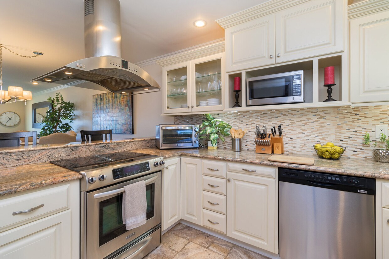 Custom cabinets and granite countertops in kitchen. - 6371 Rancho Mission Rd