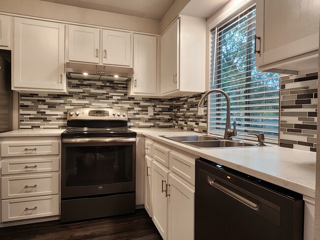 New stainless steel dishwasher. Kohler double sink with spray faucet - 1411 E Hays St