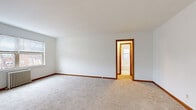 This 510 square foot apartment in St. Louis Park, Minnesota, offers a efficient living space with two bedrooms and one bathroom. The primary bedroom is notably spacious at 230 square feet, providing ample room for a comfortable retreat. The apartment's layout includes two hallways, enhancing the flow between rooms.

The kitchen is well-equipped with white cabinetry, providing ample storage space. It features modern appliances, including a refrigerator and stove, and a clean, bright aesthetic with its white color scheme and natural light from the window.

The bathroom is fully tiled in white, creating a clean and bright atmosphere. It includes a bathtub with a shower, toilet, and window that allows natural light to filter in.

The living areas and bedrooms are carpeted, adding warmth and comfort to the space. Large windows in the rooms provide natural light and views of the surrounding area. The apartment features simple, neutral-toned walls, allowing for personal decorating preferences.

Built-in closets with wooden shelving offer additional storage solutions. The apartment also includes ceiling fans for improved air circulation and comfort.

Overall, this compact apartment maximizes its 510 square feet efficiently, providing a comfortable living space with all necessary amenities in a convenient St. Louis Park location.