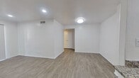 This well-appointed 2-bedroom, 2-bathroom single-story residence offers a thoughtfully laid-out floor plan with a cohesive, modern aesthetic throughout. The open-concept living and kitchen area serves as the heart of the home, featuring light wood-look flooring, recessed lighting, and a seamless flow between spaces. The kitchen is equipped with white shaker-style cabinetry, granite countertops, stainless steel appliances including a dishwasher and range, and a deep single-basin sink — combining both style and functionality.

The living area is bright and open, with flush-mount lighting and easy access to the rest of the unit via a connecting hallway. Both bedrooms are generously proportioned, featuring wood-look flooring, white walls, and ample natural light from large windows with blinds. The primary bedroom includes a ceiling fan and dedicated closet space, while a separate walk-in closet with built-in shelving provides additional storage. Each bathroom is finished with granite-topped white vanities, brushed nickel fixtures, a tub-shower combination, and matching wood-look flooring. The unit's clean, neutral palette and consistent finishes create a cohesive and move-in-ready living environment.