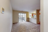 Located at 1437 Fairway Dr in Naperville, IL, this single-floor, 3-bedroom, 1-bathroom unit offers a functional and well-organized layout. The open-concept living and kitchen area forms the heart of the space, with plush carpeting underfoot and neutral beige walls that create a warm, cohesive atmosphere. A sliding glass door in the living room provides direct access to a private balcony with outdoor views, filling the space with natural light.

The kitchen features warm-toned wood cabinetry, a breakfast bar countertop that opens to the living area, and a full suite of appliances including a refrigerator, electric range, microwave, and sink — making it both practical and connected to the main living space.

Three carpeted bedrooms offer comfortable retreats, with the primary bedroom benefiting from its own sliding glass door to the balcony and ample natural light. Additional bedrooms are bright with large windows overlooking the surrounding neighborhood.

The full bathroom is finished with wood-look flooring, a wood-accented vanity with a white countertop, a tub-shower combination, and built-in shelving for added storage. A dedicated laundry room houses a full-size washer and dryer alongside a water heater. A separate closet rounds out the storage options in this efficiently designed Naperville residence.