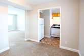 Located at 7703 Major Ave in Norfolk, Virginia, this single-floor home offers a practical and straightforward layout designed for comfortable everyday living. The living area is generously sized, featuring warm neutral-toned carpet underfoot and a wide window that invites natural light into the space, creating a bright and open atmosphere. An adjacent area flows seamlessly toward the rest of the home, offering flexible use of space.

The kitchen is equipped with warm wood-toned cabinetry, a gas range with overhead ventilation, and a stainless steel sink positioned beneath a window. Ample cabinet storage makes the kitchen both functional and efficient.

The home includes multiple carpeted bedrooms, each finished with neutral walls and ceiling light fixtures. Several bedrooms feature built-in closets with shelving and hanging rods, providing practical storage solutions. One bedroom offers dual closets, maximizing storage capacity.

The bathroom features white square tile surround on the tub and shower combination, complemented by chrome fixtures and a window that allows natural light to brighten the space.

Throughout the home, consistent neutral paint tones, white trim, and plush carpeting create a clean, cohesive aesthetic that is move-in ready and easy to personalize.