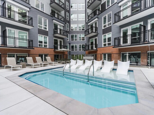 Relax in style on in-water loungers and soak up the calm atmosphere of this beautifully designed pool courtyard. - Modera H Street