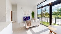 Located in Miami, FL, this modern 2-bedroom, 2-bathroom residence offers a bright, thoughtfully designed open-concept layout with a clean, contemporary aesthetic. The combined living, dining, and kitchen area serves as the heart of the home, anchored by a striking marble-veined quartz waterfall island with an undermount sink. Light wood shaker cabinetry, stainless steel appliances, and a full-size refrigerator complete the well-appointed kitchen. The living area is bathed in natural light through dramatic floor-to-ceiling black-framed windows that open to views of lush greenery and an outdoor space, creating a seamless indoor-outdoor feel. The primary bedroom features soaring windows overlooking mature trees, filling the room with natural light, and includes a dedicated walk-in closet. The second bedroom is versatile and bright, suitable as a guest room or home office. Both bathrooms mirror each other in design, each featuring a tub-shower combo with neutral tile surround, a white vanity, and clean finishes. Additional highlights include five closets providing generous storage, an in-unit laundry area, and a consistent light-toned flooring throughout that enhances the airy, minimalist ambiance of this well-crafted residence.