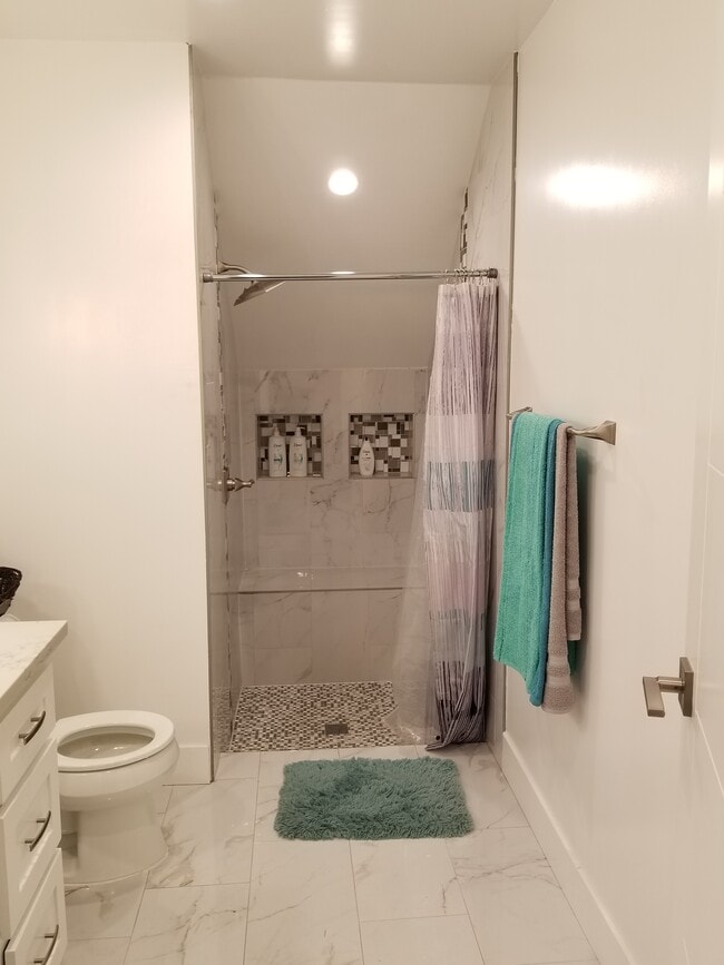 Step in shower with bench. - 4449 S Slauson Ave