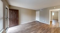 Located at 3609 Forrest Ave in Memphis, TN, this single-floor, 2-bedroom, 1-bathroom home offers a practical and well-appointed layout. Wood-look flooring runs throughout the living areas and bedrooms, providing a cohesive look and easy maintenance. Neutral gray walls complement the bright white trim and baseboards found throughout the space.

The combined kitchen and living area forms the heart of the home. The kitchen features white cabinetry, granite-look countertops, a stainless steel sink, and black appliances including a refrigerator, dishwasher, and electric range. A window above the counter brings in natural light. The adjacent living space is open and well-lit, with a front entry door that includes a security screen and a window facing the exterior.

Both bedrooms are comfortably sized with natural light provided by windows and ample closet access — the home includes four closets total. The primary bedroom offers a generous footprint. The bathroom is finished with a classic white subway tile tub-surround with a chrome shower fixture, offering a clean, timeless aesthetic.

Additional features include a dedicated laundry area and a utility room, adding to the home's functional appeal. Textured ceilings are present in select rooms, and HVAC vents are integrated throughout for year-round comfort.
