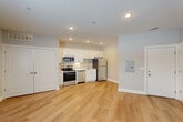 Located at 6276 Newton Rd in Haslett, Michigan, this 1-bedroom, 1-bathroom unit offers a clean, modern aesthetic throughout its efficiently arranged single-floor layout. The open living and kitchen area is anchored by light-toned hardwood flooring that extends throughout, creating a bright and cohesive feel. Recessed lighting illuminates the space evenly, enhancing its fresh, contemporary character.

The kitchen is a standout feature, outfitted with crisp white shaker-style cabinetry extending to the ceiling for ample storage, light countertops, a stainless steel sink with a modern gooseneck faucet, and a full suite of stainless steel appliances including a range, microwave, dishwasher, and refrigerator. A tiled backsplash adds a polished finishing touch.

The bedroom offers a comfortable, well-proportioned retreat finished with neutral carpet, warm beige walls, and a window with blinds that allows for natural light and outdoor views. A dedicated closet provides convenient storage.

The bathroom continues the unit's clean design with hardwood-style flooring, a bathtub and shower combination fitted with brushed gold fixtures, and a well-organized layout with toilet and vanity. The warm metallic hardware adds a refined accent throughout the space. Overall, this unit presents a move-in-ready environment with modern finishes and a practical, well-structured layout.