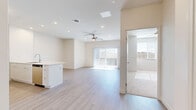 Located in Maricopa, Arizona, this well-appointed single-story, 1-bedroom, 1-bathroom home offers a thoughtfully designed layout with modern finishes throughout. Light wood-look flooring spans the main living areas, creating a clean, cohesive aesthetic complemented by neutral tones and crisp white walls.

The open-concept kitchen and living room form the heart of the home. The kitchen is outfitted with stainless steel appliances, including a refrigerator, range, and dishwasher, alongside white cabinetry that extends to the ceiling for ample storage. A peninsula with an undermount sink provides both workspace and casual seating. The living area is bright and airy, benefiting from a ceiling fan, recessed lighting, and a sliding glass door with vertical blinds that opens to the balcony, flooding the space with natural light.

The spacious primary bedroom features its own ceiling fan, while the dedicated closet offers wire shelving and carpeted flooring for comfort. A versatile den provides additional flexible space. The full bathroom is finished with a tiled tub-and-shower combination, white cabinetry with quartz countertops, and wood-look flooring. Additional conveniences include a utility room, dedicated laundry area, and a welcoming entrance. The balcony offers an outdoor retreat ideal for the Arizona climate.