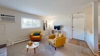 Located at 1440 S Neltnor Blvd in West Chicago, IL, this well-appointed 2-bedroom, 1-bathroom unit offers a comfortable and functional single-floor layout. The living room is a welcoming space featuring carpet flooring, a wall-mounted air conditioning unit, baseboard heating, and a wide window that brings in natural light and outdoor views — providing ample room for living and entertaining. The kitchen stands out with its updated grey cabinetry, stainless steel appliances including a refrigerator and dishwasher, a subway tile backsplash, light countertops, and wood-style flooring that adds warmth to the space. The spacious primary bedroom features soft carpet flooring, a large window with outdoor views, baseboard heating, and an expansive bank of built-in closets offering excellent storage. The second bedroom is versatile and cozy, also with carpet, a window, and baseboard heating — well-suited as a guest room, office, or flex space. The bathroom includes a single vanity with updated cabinetry, a tub-shower combination with tile surround, and wood-style flooring. A hallway connects the rooms, completing this efficiently designed and move-in-ready home.