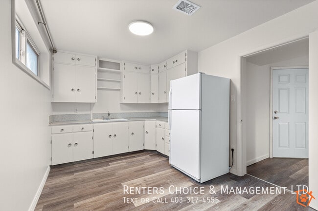 Building Photo - Pet Friendly Suite with Fenced Yard + Driveway Parking