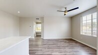 Located at 2555 Fenton Pkwy in San Diego, California, this well-appointed one-bedroom, one-bathroom residence offers a thoughtfully designed single-level layout with a clean, modern aesthetic throughout. Light neutral tones and wood-look flooring unify the space, creating a cohesive and contemporary feel.

The open-concept kitchen and living area serves as the heart of the home. The kitchen is equipped with a full suite of stainless steel appliances — including a gas range, microwave, refrigerator, and dishwasher — complemented by crisp white cabinetry, quartz countertops, and a kitchen island with additional sink access. Recessed lighting enhances the bright, functional atmosphere.

The bedroom is a comfortable retreat featuring wood-look flooring, a ceiling fan with light fixture, and a generously sized window with outdoor views of the surrounding neighborhood, allowing ample natural light to fill the room. A dedicated closet provides convenient storage.

The bathroom includes a full tub-and-shower combination, a white vanity, and consistent flooring that ties the space together cleanly. A dedicated in-unit laundry area with a front-loading washer and shelving adds practical convenience. The space also includes a closet for additional storage needs.