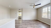 Located at 2555 Fenton Pkwy in San Diego, California, this well-appointed one-bedroom, one-bathroom residence offers a thoughtfully designed single-level layout with a clean, modern aesthetic throughout. Light neutral tones and wood-look flooring unify the space, creating a cohesive and contemporary feel.

The open-concept kitchen and living area serves as the heart of the home. The kitchen is equipped with a full suite of stainless steel appliances — including a gas range, microwave, refrigerator, and dishwasher — complemented by crisp white cabinetry, quartz countertops, and a kitchen island with additional sink access. Recessed lighting enhances the bright, functional atmosphere.

The bedroom is a comfortable retreat featuring wood-look flooring, a ceiling fan with light fixture, and a generously sized window with outdoor views of the surrounding neighborhood, allowing ample natural light to fill the room. A dedicated closet provides convenient storage.

The bathroom includes a full tub-and-shower combination, a white vanity, and consistent flooring that ties the space together cleanly. A dedicated in-unit laundry area with a front-loading washer and shelving adds practical convenience. The space also includes a closet for additional storage needs.