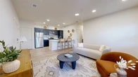 Located at 2525 S Meadows Rd in Santa Fe, NM, this well-designed single-floor residence offers 2 bedrooms and 2 bathrooms with a thoughtful, modern layout. The open-concept kitchen and living area forms the heart of the home, featuring light wood-look flooring, recessed lighting, and a bright, neutral color palette throughout. The kitchen is outfitted with dark navy cabinetry, white quartz countertops, stainless steel appliances including a refrigerator, electric range, and microwave, plus a peninsula with bar seating that connects seamlessly to the living space. The living room is generously sized with large windows dressed in linen curtains, allowing abundant natural light, and includes access to a private patio. The primary bedroom is a comfortable retreat with a walk-in closet, natural light from a window with outdoor views, and warm wood flooring. Both bathrooms feature wood-tone luxury vinyl flooring, dark vanity cabinetry with white counters, and a tub-shower combination. Additional highlights include a dedicated laundry area, a hallway with entryway space, and an impressive five closets offering exceptional storage. The overall ambiance is clean, contemporary, and inviting.