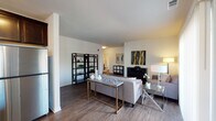 Located at 1831 Covington Ct in St. Charles, Illinois, this single-story residence offers a thoughtfully designed layout with a contemporary aesthetic. The open-concept living area serves as the heart of the home, featuring warm wood-look flooring, neutral walls, and a fireplace that anchors the space. Large vertical blinds frame a sliding door, allowing abundant natural light to filter through and creating a bright, welcoming atmosphere.

The kitchen is equipped with dark espresso cabinetry, granite countertops, stainless steel appliances including a gas range, microwave, and refrigerator, and track lighting overhead. An adjacent dining area benefits from multiple windows on two walls, providing views of the surrounding neighborhood and filling the space with natural light. A pendant light fixture adds a classic finishing touch above the dining table.

The bedrooms offer plush carpeting, generous window placement for natural light, and soft neutral tones that create a restful environment. Bathrooms feature wood-look flooring and clean, minimalist finishes. Throughout the residence, the design balances modern functionality with comfortable, understated elegance, making it a cohesive and inviting living space.