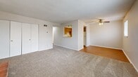Located at 4424 NW Hon Dr in Riverside, Missouri, this single-floor, 2-bedroom, 1-bathroom unit offers a practical and functional layout across a comfortable footprint. The living room serves as the central gathering space, featuring neutral carpet, a textured ceiling, a ceiling fan with light fixture, and a brick fireplace with decorative glass doors — a notable focal point in the room. A window allows natural light to filter in, creating a bright and welcoming atmosphere.

The kitchen connects to the living area via a pass-through window opening, providing an open feel between the two spaces. It features warm wood-toned cabinetry, hardwood flooring, a double sink, dishwasher, and a full-size refrigerator. A hallway connects the main living area to the bedrooms and bathroom.

The spacious primary bedroom includes two windows that bring in ample natural light and offers a generously sized closet with bi-fold doors. The second bedroom also features carpet, a window, and a closet with bi-fold doors. The bathroom includes a full tub-shower combination with white tile surround and clean white fixtures. Textured ceilings are consistent throughout the unit.