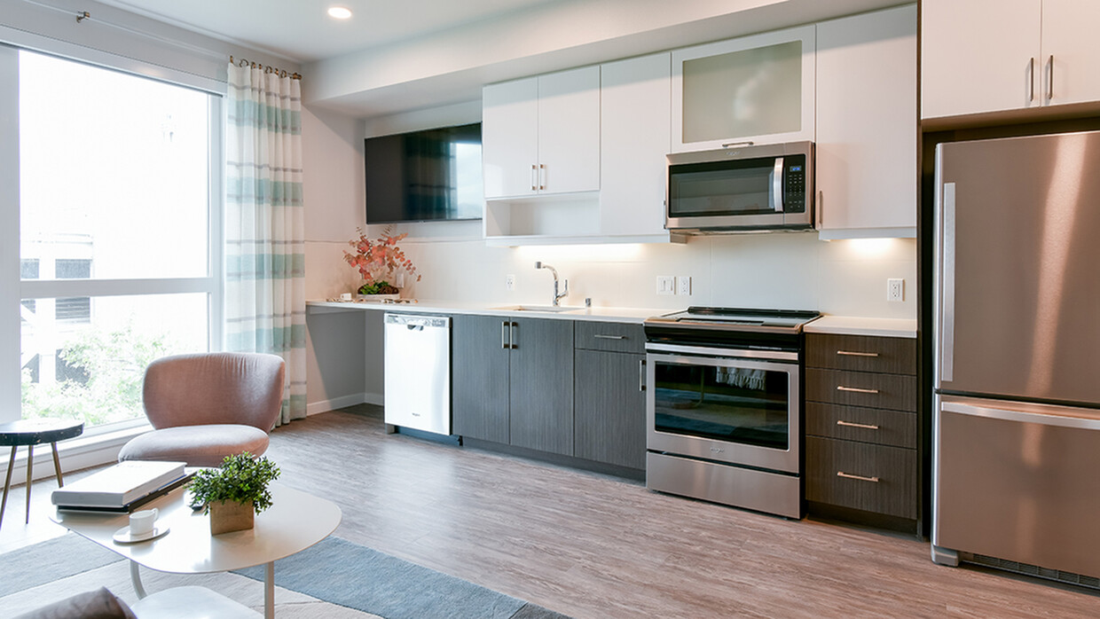 Stunning Galley-style kitchens with stainless steel appliances and wood plank flooring - Modera San Pedro Square