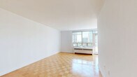 Located on the 16th floor at 450 Walmer Road in Toronto's prestigious Forest Hill neighbourhood, this well-appointed two-bedroom, one-bathroom unit offers a comfortable and functional layout across a single floor. Warm parquet flooring flows consistently throughout the living areas and bedrooms, lending the space a classic, cohesive character.

The spacious living room is bathed in natural light through large picture windows that frame sweeping city views, creating an open and airy atmosphere. A sliding door provides access to an outdoor balcony, further enhancing the connection to the urban landscape beyond.

Both bedrooms are generously proportioned, each featuring parquet flooring, white walls, and large windows that invite abundant natural light. Built-in closets with double doors provide ample storage. The primary bedroom offers a comfortable footprint well-suited for a full bedroom suite.

The kitchen is equipped with white cabinetry, marble-style countertops, and a stainless steel sink, offering a clean and practical workspace. A connecting hallway provides a logical transition between rooms.

The bathroom features a full soaker bathtub surrounded by classic cream tiles with subtle decorative accents, offering a calm and functional retreat. Overall, the unit presents a bright, clean, and move-in-ready space with desirable elevated city views.