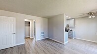 Located at 3044 G St in Merced, CA, this single-floor 1-bedroom, 1-bathroom unit offers a well-organized layout with modern updates throughout. Light gray luxury vinyl plank flooring runs continuously through each room, complemented by neutral taupe walls and textured ceilings that give the space a clean, cohesive look.

The open living area features a window overlooking greenery, a wall-mounted A/C unit, and a front entry door that brings in natural light. The kitchen is efficiently designed with gray shaker-style cabinetry, light stone-look countertops, recessed lighting, and stainless steel appliances including a range and refrigerator — providing ample functionality in a compact footprint.

The bedroom is a comfortable size, featuring a window with blinds, a wall-mounted A/C unit, and easy access to one of three closets in the unit, including a spacious walk-in closet. Storage is a notable strength of this layout.

The bathroom is finished with a gray vanity with brushed nickel hardware, a single-basin sink, and a full tub-shower combination enclosed by sliding frosted glass doors. The space is bright and clean with consistent flooring throughout.

A private patio offers outdoor access, adding to the unit's livability. Mature trees visible from the windows provide a touch of natural scenery.