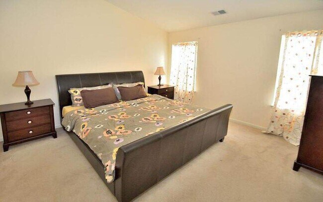 Master bedroom with vaulted ceilings and skylight! - 14614 Stream Pond Dr
