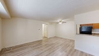 Located at 511 E Gibbsboro Rd in Lindenwold, NJ, this single-story unit offers a well-organized layout designed for comfortable everyday living. Light-toned luxury vinyl plank flooring runs consistently throughout the living areas and bedrooms, creating a cohesive and easy-to-maintain aesthetic.

The living area is generously sized, featuring neutral cream-toned walls, a ceiling fan with integrated lighting, and access to natural light through large windows overlooking greenery outside. The layout flows naturally between a secondary sitting or dining area and the kitchen, connected via a pass-through countertop for added convenience.

The kitchen is well-appointed with warm honey-toned wood cabinetry, stone-patterned countertops, and a full suite of stainless and black appliances, including a gas range, dishwasher, and refrigerator. Light flooring continues here, reinforcing the unit's clean, unified design.

The bedrooms are quiet and functional, each featuring neutral walls, LVP flooring, and windows that bring in natural light. At least one bedroom includes a built-in closet with bifold doors, offering practical storage. The bathroom features white cabinetry, a granite-style vanity countertop, a large mirror with a lighted fixture above, and neutral tile flooring throughout.