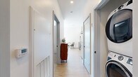 Located at 41 Seacoast Ter. in Kittery, Maine, this thoughtfully designed one-bedroom, one-bathroom unit makes excellent use of its compact footprint across a single floor. A clean, light-filled hallway with light wood-style flooring and recessed lighting connects all areas of the home, creating a cohesive and organized layout.

The kitchen is a standout feature, outfitted with sleek grey flat-front cabinetry extending to the ceiling for ample storage, light quartz countertops, a matte black pull-down faucet, and a full suite of stainless steel appliances including a refrigerator, range, microwave, and dishwasher. Light hardwood flooring adds warmth and continuity throughout the kitchen and living areas.

The living room benefits from a large window that invites natural light, creating a bright and comfortable space. The bedroom features plush carpeting and includes access to a dedicated closet, providing practical storage. The bathroom is finished with large-format tile flooring, a grey vanity with a white countertop, and a full tub/shower combination with matte black fixtures. In-unit laundry is also present, adding everyday convenience to this well-appointed home.