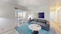 Located at 100 Larissa Ln in Vallejo, CA, this single-floor 2-bedroom, 2-bathroom residence offers a clean, modern aesthetic defined by light wood flooring, crisp white walls, and an abundance of natural light throughout. The open-concept living and dining area serves as the heart of the home, featuring a sliding glass door that leads to a private outdoor deck — ideal for enjoying California's natural surroundings. The kitchen is efficiently designed with white cabinetry, granite-style countertops, and stainless steel appliances including a range and refrigerator, all connected to the living space via a convenient pass-through window. The primary bedroom is a well-proportioned retreat filled with natural light from large windows, complemented by sliding mirrored closet doors that enhance the sense of space. The second bedroom also benefits from bright window views and ample closet storage. Both bathrooms are finished with light wood flooring, vanities with countertop sinks, and tub-shower combinations. A central hallway connects all rooms efficiently, and with six closets throughout, storage is plentiful. The overall ambiance is bright, clean, and functional — a comfortable home with a contemporary feel.