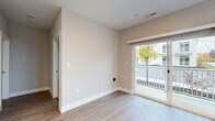Located at 19145 Double Loop Dr in Aurora, OH, this well-appointed one-bedroom, one-bathroom unit offers a thoughtfully designed single-floor layout. The entrance opens into a bright hallway with light wood-style flooring that flows throughout the main living areas. The combined kitchen and living room serves as the heart of the unit, featuring a peninsula with granite countertops, white shaker-style cabinetry, and a full suite of stainless steel appliances including a refrigerator, electric range, microwave, and dishwasher. Recessed lighting and a window over the sink provide excellent natural light. The living area is anchored by sliding glass doors that open to a private balcony with outdoor views. The bedroom is a comfortable, carpeted retreat with a large window that fills the room with natural light. The bathroom mirrors the refined finishes found throughout the unit, showcasing granite countertops, a white vanity with shaker-style cabinetry, and a walk-in glass shower. Additional conveniences include a dedicated laundry area, a hallway closet for storage, and a clean, neutral color palette that lends a modern, move-in-ready feel to the entire space.