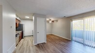 Located at 2946 Francis St in Kansas City, KS, this one-bedroom, one-bathroom unit offers a practical and comfortable single-floor layout. The open-concept living and kitchen area is finished with light hardwood-style flooring throughout, neutral-toned walls, and a textured ceiling. A ceiling fan adds functionality to the living space, which is brightened by a sliding glass door fitted with vertical blinds that allows natural light to pour in and provides outdoor access. The kitchen is efficiently designed with warm wood cabinetry, granite-style countertops, a stainless steel sink with a black pull-down faucet, and stainless steel appliances including a refrigerator, range, dishwasher, and microwave. A hallway connects the main living area to the private spaces. The bedroom features plush carpeting, two windows with blinds for natural light, a double-door closet, and a textured ceiling, creating a cozy retreat. The bathroom is clean and functional, offering a tub-shower combination with grab bars, a vanity with a white countertop and wood cabinetry, and a mirror. Overall, the space presents a well-maintained, move-in-ready layout suited for comfortable everyday living.